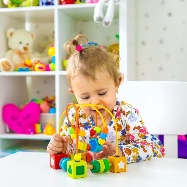 The child plays with toys in the room. Selective focus. Baby.