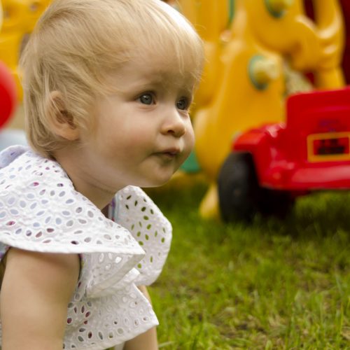 portrait-cute-girl-playing-with-toy-field
